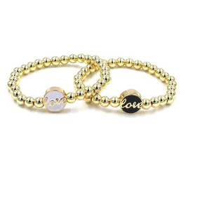 Ashley Gold Stainless Steel Gold Plated Enamel "Love" Disc Beaded Stretch Bracelet